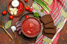Bowl With Tasty Borscht, Bread And Ingredients On Grunge Background