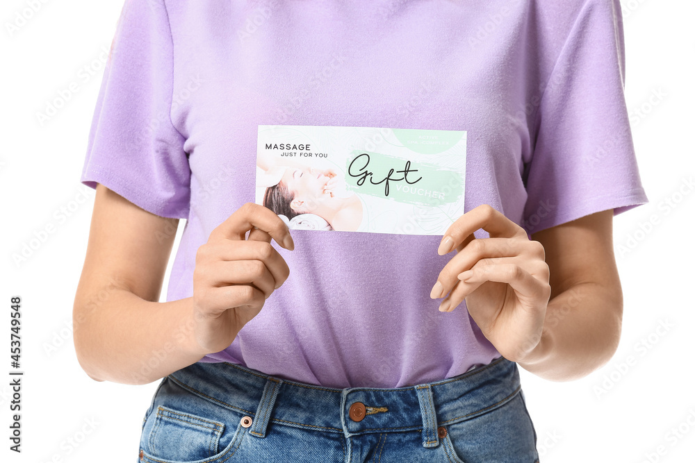 Young woman with gift certificate for massage on white background