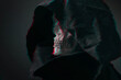Concept image grim Reaper. Close up view skull in black hood, on dark background. Glitch effect.