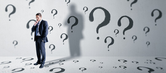 Aufkleber - Thoughtful young european business man standing in concete interior with question mark sketch. Solution and brainstorm concept.