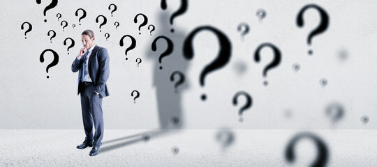 Aufkleber - Thoughtful young european businessman standing in concete interior with question mark sketch. Solution and brainstorm concept.