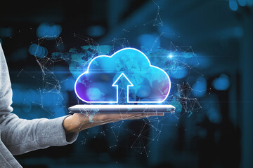 Poster - Hand holding tablet with abstract glowing cloud hologram on blurry interior background. Cloud computing, future and data storage concept. Double exposure.