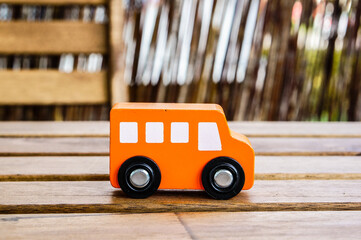 Wall Mural - Closeup shot of a wooden orange toy bus