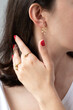 Women jewelry concept idea, gold earring and ring on beautiful woman, vertical jewelry concept.
