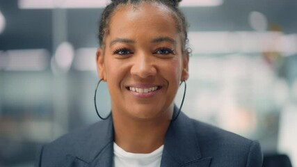 Poster - Portrait of a Confident Happy Adult Middle Aged African American Female Wearing Dark Jacket, Looking at Camera, Posing and Charmingly Smiling. Successful Black Woman Working in Diverse Company Office.