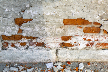 Embossed textured surface of an old wall made of facade bricks and cement