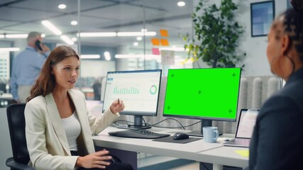 Poster - Two Female Colleagues Fondly Talk to Each Other, Laugh and Smile while Working on Computers with Green Screen Mock Up Display in Modern Business Office. Manager and Employee Discuss a Fun Project.