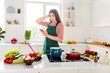 © deagreez - Photo of impressed funny housewife dressed green apron typing modern device cooking breakfast indoors house room home