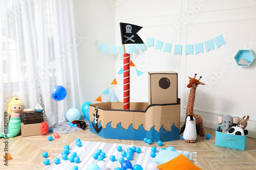 Child\'s room interior with pirate cardboard ship and toys