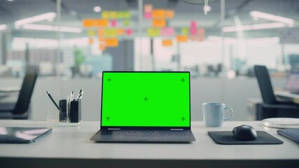 Aufkleber - Laptop Computer with Mock Up Green Screen Chroma Key Display Standing on the Desk in the Modern Creative Office. In the Background Glass Wall with Colorful Planning Notes. Zoom in Shot.