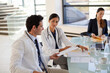 © KOTO - Doctors and businesswoman talking in meeting