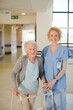 © KOTO - Nurse helping senior patient with walker in hospital corridor
