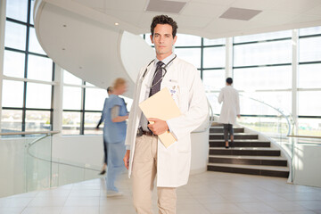 Wall Mural - Portrait of smiling doctor in hospital atrium