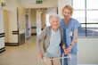 © KOTO - Nurse helping senior patient with walker in hospital corridor