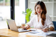 © David - Portrait of smiling beautiful business asian woman with working in modern office desk using computer, Business people employee freelance online marketing e-commerce telemarketing concept.