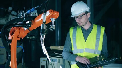 Wall Mural - construction engineer is inspecting a robotic mechanism
