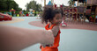 © nimito - Pov shot of little afro girl holding mother hand walking on playground