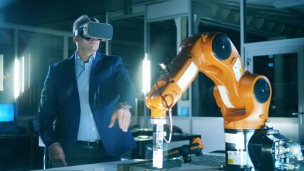 Wall Mural - male engineer is using vr-device to operate a robotic mechanism