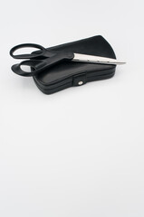 Canvas Print - Black leather closed manicure set bag and scissors with copy space