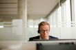 © KOTO - Businessman talking on headset in office