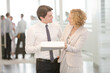 © KOTO - Business people talking in office lobby