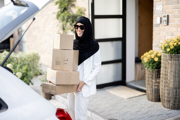 Wall Mural - Muslim woman carrying parcels home