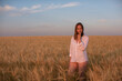 © olinchuk - Aerial view of woman lying in the yellow field of wheat