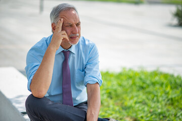 Wall Mural - Thinking and pensive businessman outdoor