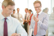 © KOTO - Businessman using cell phone in office
