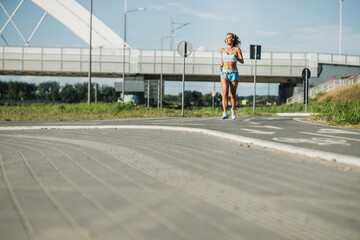 Wall Mural - Middle Age Sportswoman Jogging Outdoor