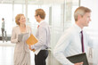 © KOTO - Business people smiling in office lobby