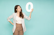 Young beautiful Asian businesswoman showing number 0 or zero isolated on green background