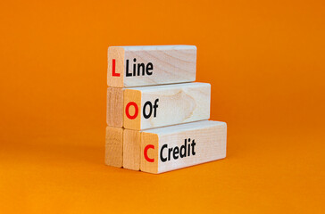 Wall Mural - LOC, Line of credit symbol. Wooden blocks with words 'LOC, line of credit'. Beautiful orange background, copy space. Business and LOC, line of credit concept.