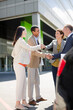 © KOTO - Business people shaking hands on city street