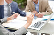 © KOTO - Business people using laptop outdoors