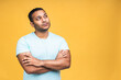 © denis_vermenko - Thinking black african American indian black man with serious expression looking, posing isolated over yellow background.