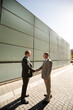 © KOTO - Businessmen shaking hands on city street