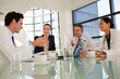 © KOTO - Doctors and businesswoman talking in meeting