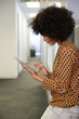 © KOTO - Portrait of woman using digital tablet in office