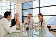 © KOTO - Doctors and businesswoman talking in meeting