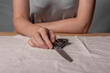 © valiantsin - Female hands, lying metal scissors over natural cloth. Concept of sewing home as trendy hobby.