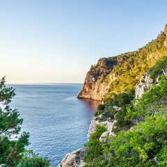 Sticker - Closeup shot of a beautiful cliff under the sunlight near the blue sea