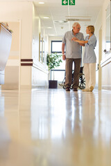 Wall Mural - Older patient and nurse standing in hospital