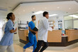 © KOTO - Hospital staff rushing down hallway