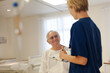 © KOTO - Nurse and older patient talking in hospital room