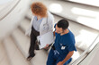 © KOTO - Doctor and nurse walking on hospital steps