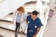 © KOTO - Doctor and nurse walking on hospital steps