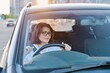 © Valerii Honcharuk - Middle-aged woman driver with glasses, female driving a car.