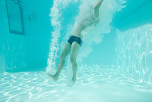 Man Posing Underwater In Swimming Pool
