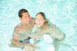 © KOTO - Couple floating in swimming pool